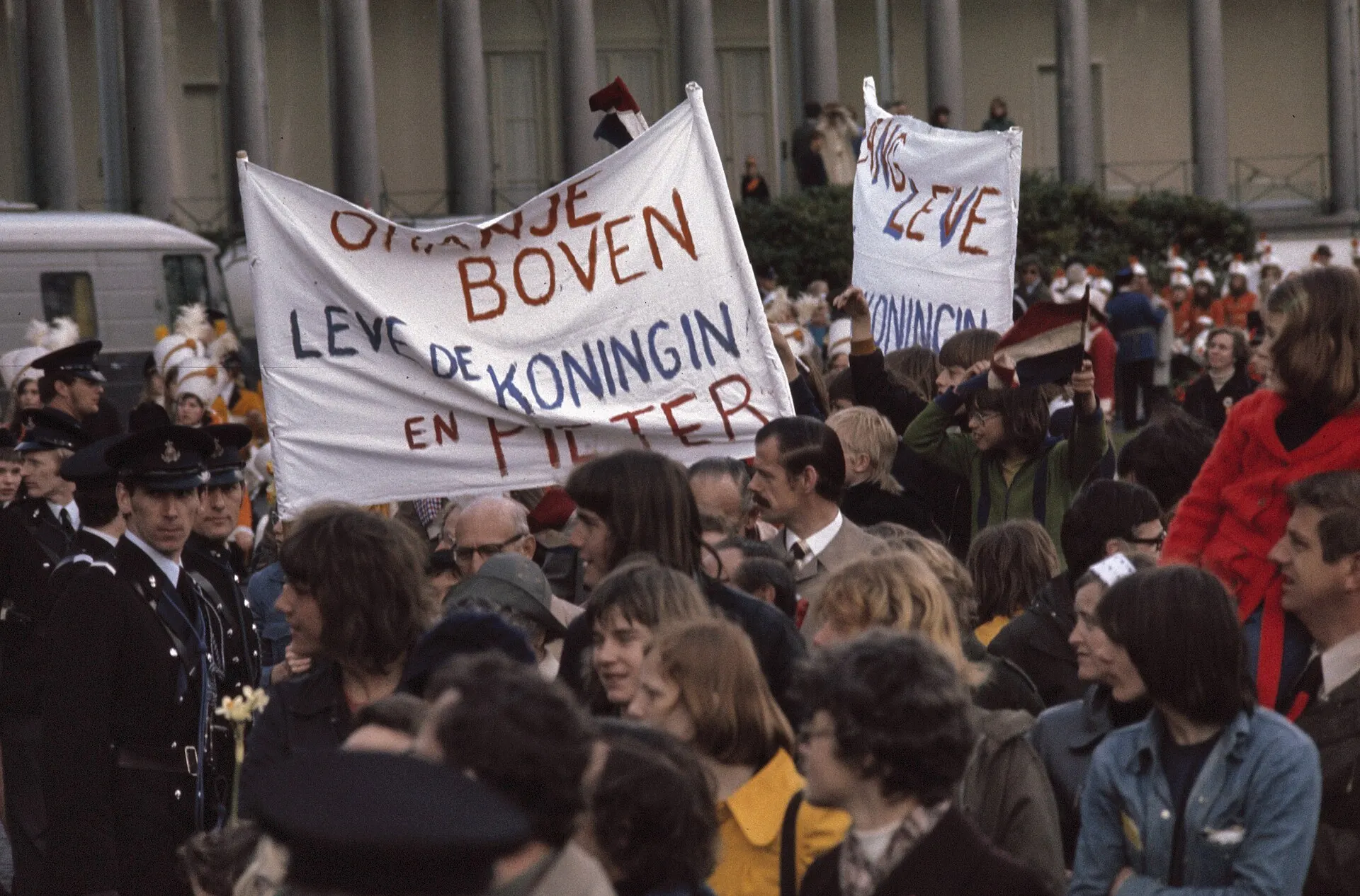 Publiek met een spandoek "Oranje boven, leve de koningin" bij Soestdijk